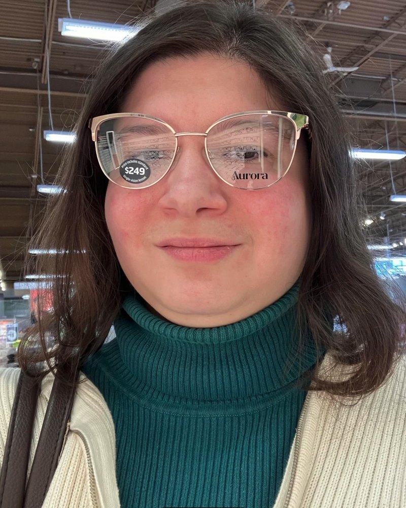 Reddit poster in a gold cat-eye frame that covers the eyebrows